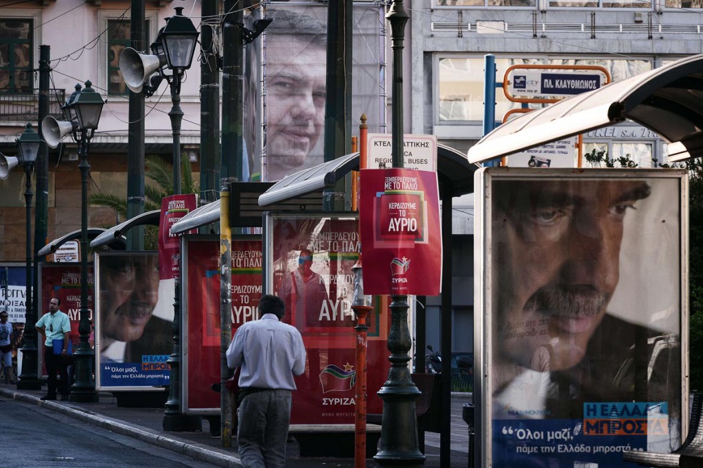 A man walks past pre-election posters featuring conservative New Democaracy leader Vangelis Meimarakis (R) and leftist Syriza leader Alexis Tsipras in central Athens on September 16, 2015. With Greece's snap elections on September 20, the top two parties are neck and neck in the polls. Analysts say a full return to power for the leftist Syriza party, while still possible, is unlikely. AFP PHOTO/ LOUISA GOULIAMAKI