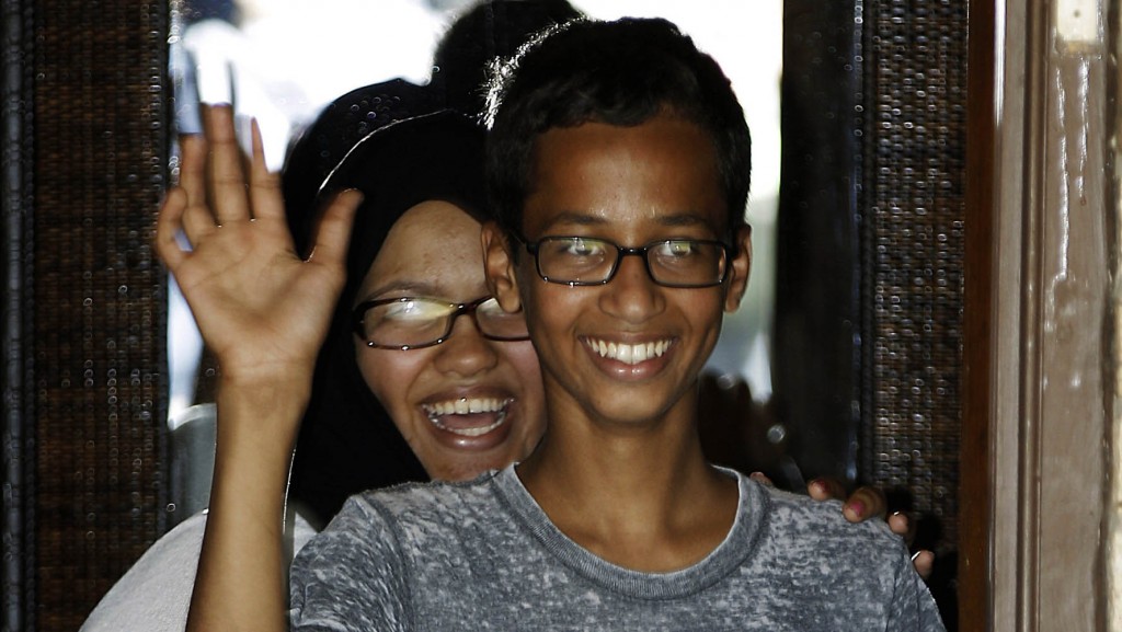 Ahmed Mohamed, 14, right, waves to the media from the front door of his house as his sister, Eyman Mohamed, looks on before a news conference, Wednesday, Sept. 16, 2015, in Irving, Texas. Ahmed was arrested after a teacher thought a homemade clock he built was a bomb. (AP Photo/Brandon Wade)