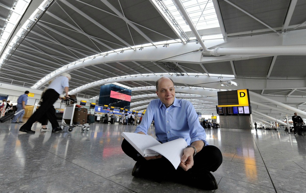 UNITED KINGDOM OUT NO SALES NO INTERNET NO MAGS In this image taken Tuesday Aug. 18, 2009 author Alain de Botton, poses for the camera at London Heathrow Airport's Terminal 5. De Botton best known for works of philosophy has become the first writer in residence at Heathrow Airport and is spending a week inside Heathrow's Terminal 5. (AP Photo) ** UNITED KINGDOM OUT NO SALES NO INTERNET NO MAGS **ÿ