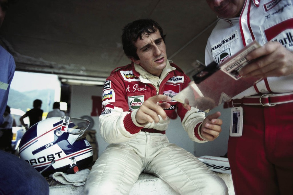 17 Aug 1980, Zeltweg, Austria --- McLaren-Ford driver Alain Prost checks notes during preparations for the 1980 Austrian Grand Prix in Zeltweg. Prost would finish seventh. --- Image by © Schlegelmilch/Corbis