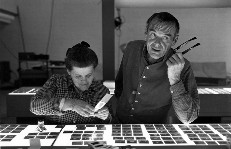 Ray and Charles Eames selecting slides for the exhibition, Photography & the City, 1968, as seen in Jason Cohn and Bill Jersey’s documentary EAMES: The Architect and the Painter. © 2011 Eames Office, LLC.